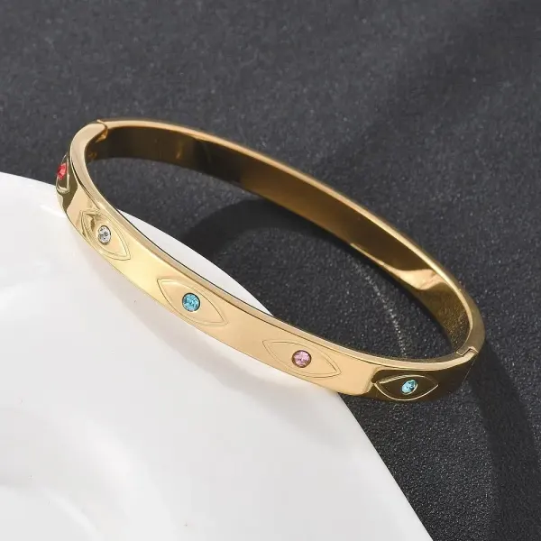 BRAZALETE CON OJOS DE ZIRCONIAS DE COLORES INCRUSTADAS